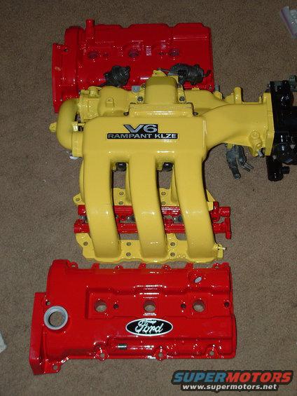 Red Ford valve covers and a yellow V6 intake manifold with 'RAMPANT KLZE' text