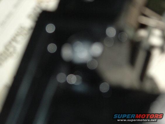 Out-of-focus interior shot showing bokeh lights and dark surfaces