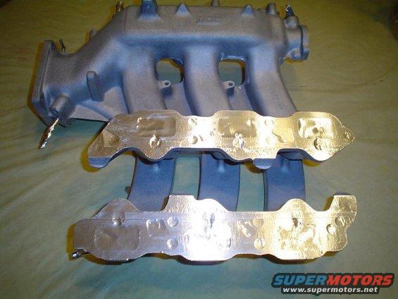 Aluminum intake manifold and two gaskets on a table