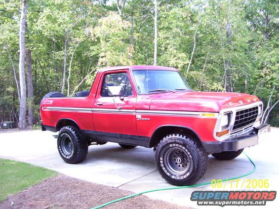 Red 1979 Ford Bronco with spare tire on rear