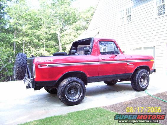 Red 1978 Ford Bronco with black trim and spare tire mounted on the rear bumper