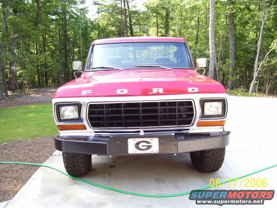 Red Ford truck front view with grille and 'FORD' lettering