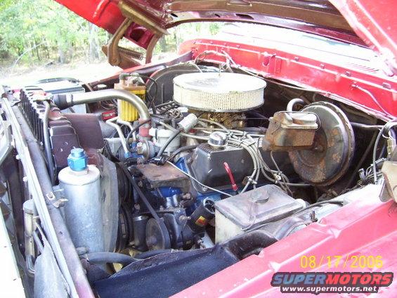 Red engine bay with V8 engine, air cleaner, and brake booster