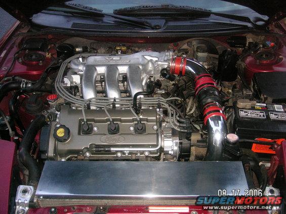 Engine bay with V6 intake manifold and red-accented intake tube