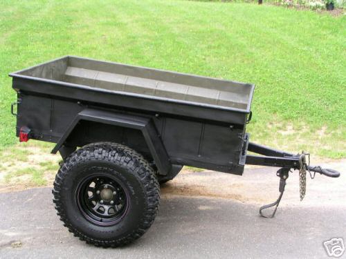 Black utility trailer with off-road tires and a trailer hitch