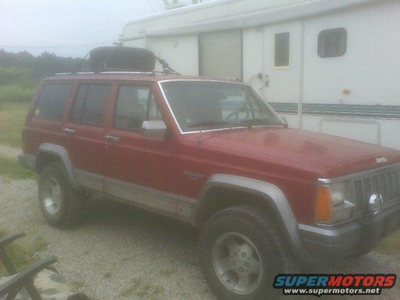 Red 1992 Jeep Cherokee with roof rack and cargo box