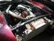 1969 Ford Mustang - The engine bay of a car features a turbocharger and custom piping, with a large radiator in front.
