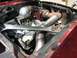 1969 Ford Mustang - This engine bay features a custom turbo setup with a prominent Holley carburetor and polished valve covers.