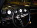 1969 Ford Ranchero - The interior of a 1969 Ford Ranchero shows a dashboard with multiple gauges and a prominent steering wheel.