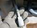 2002 Ford F-250 - Hand holding a black electrical connector with wires inside protective tubing.