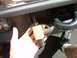2002 Ford F-250 - Close-up of a trailer hitch wiring connector being held by a hand.