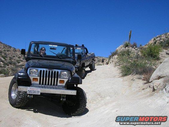 Black Jeep Wrangler front view on dirt road