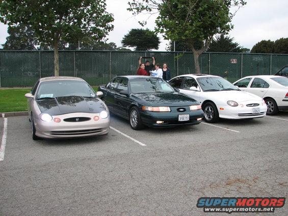Tan 1998 Mercury Sable sedan with black hood, front view