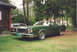 1979 Ford Ranchero - A green 1979 Ford Ranchero is parked outside a cabin, with another vehicle visible behind it.