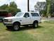 1993 Ford Bronco - This 1993 Ford Bronco is shown in a three-quarter front view, parked on a grassy lawn.