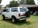 1993 Ford Bronco - Rear view of a white 1993 Ford Bronco with a spare tire mounted on the tailgate.