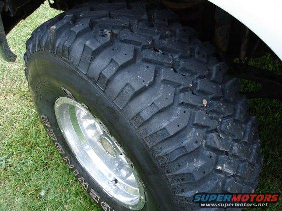 Close-up of a large off-road tire with visible text on the sidewall