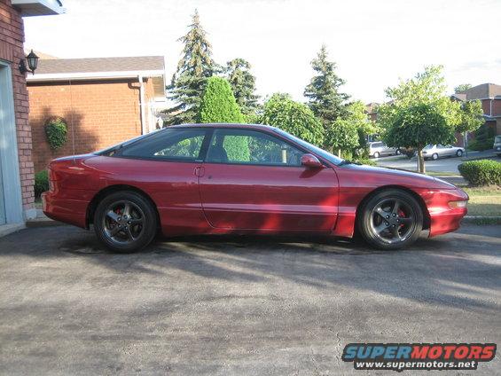 Red 1993 Ford Probe coupe, side view