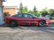 1993 Ford Probe - Side profile of a red 1993 Ford Probe coupe parked in a driveway.