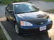 1993 Ford Probe - A dark blue coupe is parked on a paved surface with a black bug deflector on its hood.