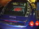 1995 Ford Taurus - Rear view of a blue Ferrari, its exposed red engine through the glass rear decklid.