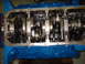 1967 Ford Fairlane - Close-up view of the internal engine components, including the crankshaft and connecting rods, set against a bright blue engine block.