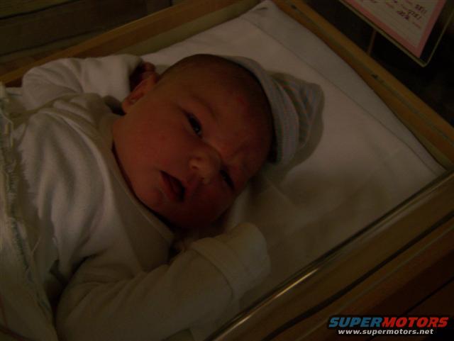 Baby in a bassinet, close-up on face and upper body