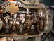 1994 Jeep YJ - The internal components of an engine, showing the crankshaft and connecting rods covered in oil.