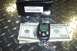 1994 Ford F-150 - Scorpio car alarm remote and box are displayed with US currency on a diamond plate surface.