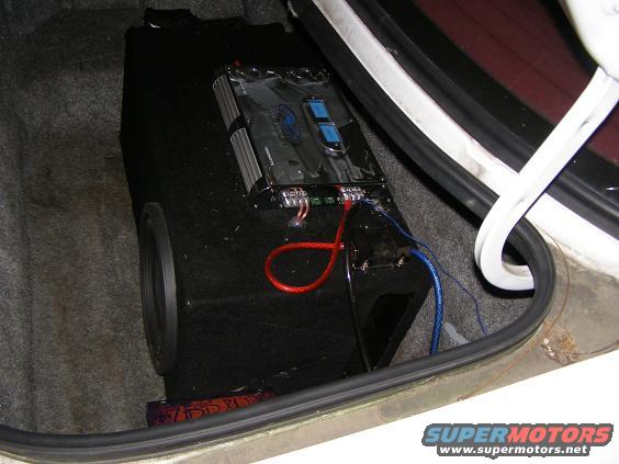 Trunk with subwoofer box and amplifier, showing wiring