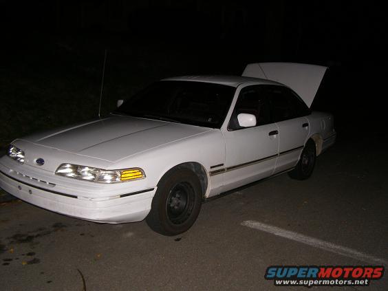 White 1992 Ford Crown Victoria sedan with trunk open, front 3/4 view, parked on asphalt