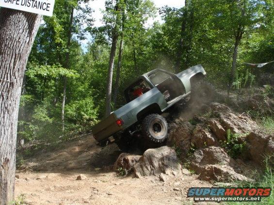 Pickup truck climbing a rocky hill off-road