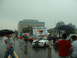 1978 Ford Mustang II - Cars gather for the Mustang Alley event on a wet day, with a banner overhead.