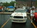 1978 Ford Mustang II - A white 1978 Ford Mustang II is parked at an outdoor car show with other vehicles and people around.