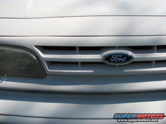 Close-up of 2003 Ford Crown Victoria grille with Ford emblem and headlight
