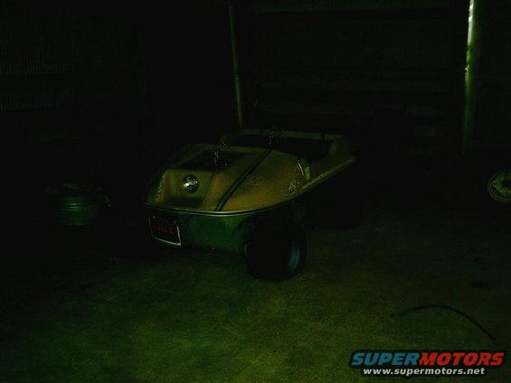 Golf cart with yellow and green body, red license plate