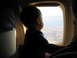 2002 Ford Taurus - A child gazes out an airplane window at the landscape below.