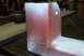 1983 Ford Bronco - A metal component, possibly a crossmember, is shown with a red base coat and white overspray, revealing visible welds.
