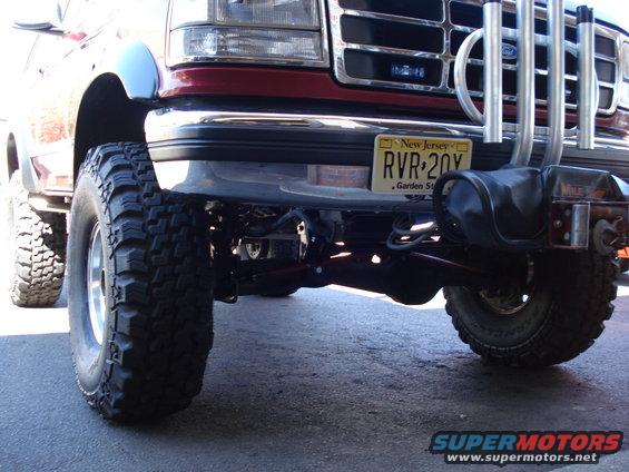 Red Ford truck front end, lifted with large tires, New Jersey license plate RVR 20Y