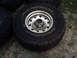 1996 Ford Bronco - A BFGoodrich Mud Terrain T/A tire mounted on a silver 5-lug wheel is shown close-up.