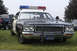 1978 Dodge Monaco - This 1978 Dodge Monaco police car features a classic light bar and a California license plate, seen parked on grass with other vehicles in…
