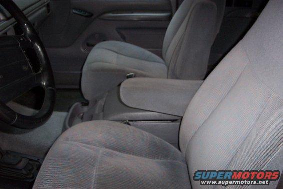 1995 Ford Bronco interior with gray cloth seats, center console armrest, and steering wheel