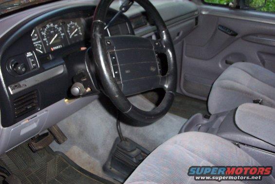 1995 Ford Bronco interior showing dashboard, steering wheel, and seats. "SUPERMOTORS www.supermotors.net" watermark visible