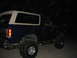 1989 Ford Bronco - This 1989 Ford Bronco is seen at night with its distinctive white removable top and large off-road tires.