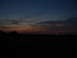 1989 Ford Bronco - The sky shows a gradient of colors at dusk, with a dark foreground and a faint red light in the distance.