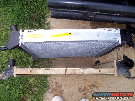 Two radiators, one new and one old, laid out on the ground