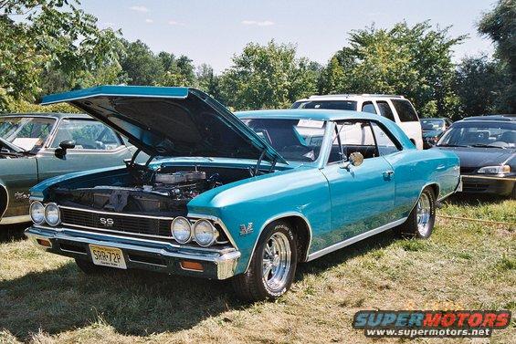 1966 Chevrolet Chevelle SS coupe with hood open, parked on grass next to other cars
