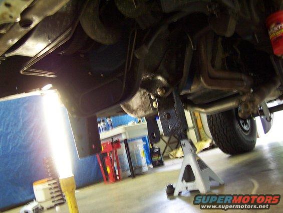 1983 Ford Bronco underbody with exhaust and suspension visible, vehicle supported by jack stands