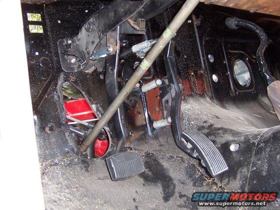 Close-up of a vehicle's firewall with brake and clutch pedals visible