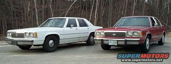 Two Ford Crown Victorias parked side-by-side. The one on the left is white, and the one on the right is maroon. Both have their front ends visible